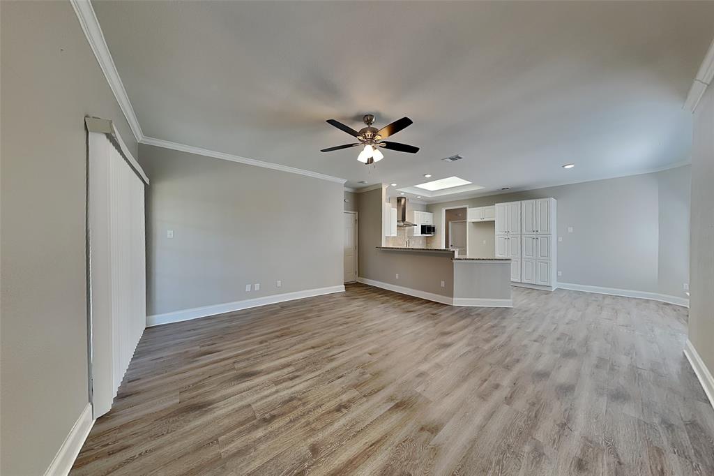 806 Kipling Drive Allen, TX 75002 - Photo 2 of 19 a view of an empty room with wooden floor and a ceiling fan