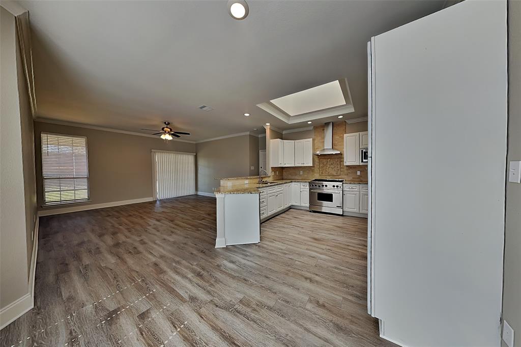 806 Kipling Drive Allen, TX 75002 - Photo 7 of 19 a large kitchen with cabinets wooden floor and stainless steel appliances