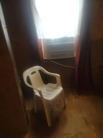 a bed sitting in a bedroom next to a lamp