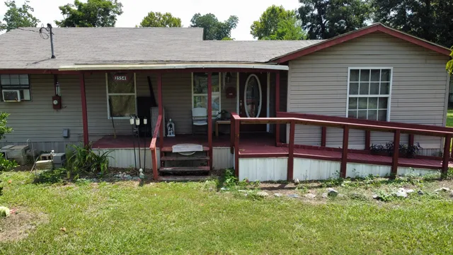 a view of a house with a yard and sitting area