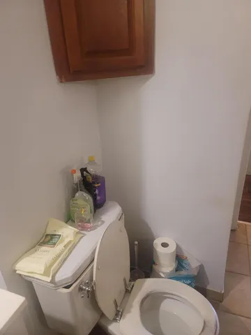 a kitchen with granite countertop white cabinets and black appliances