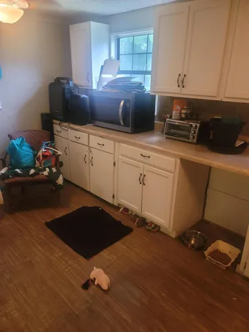 a kitchen with a cabinets and white appliances