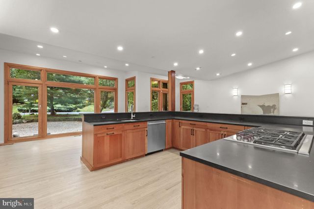 a living room with furniture a fireplace and a floor to ceiling window