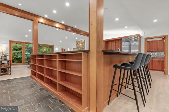 a living room with furniture a rug and a large window