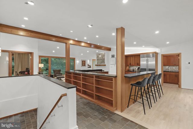 a view of a dining room with furniture a livingroom and chandelier