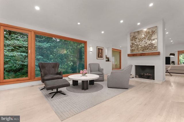 a living room with furniture tv and a large window