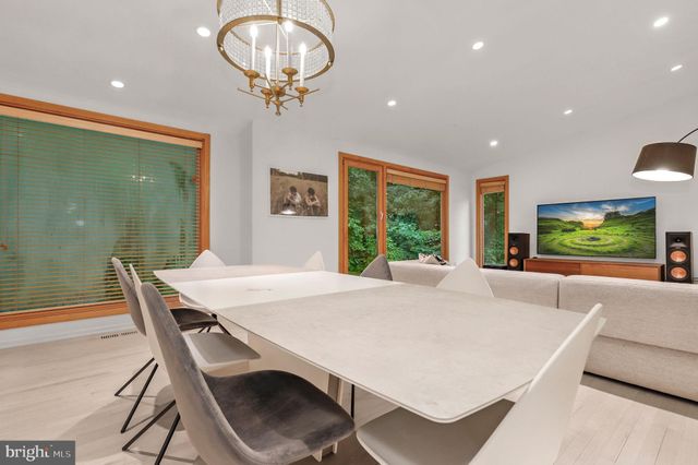 a bedroom with a bed and furniture with large window