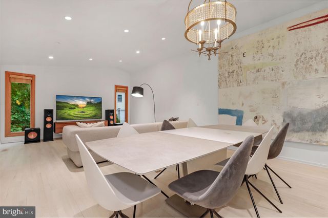 a bedroom with a bed lamp and a large window