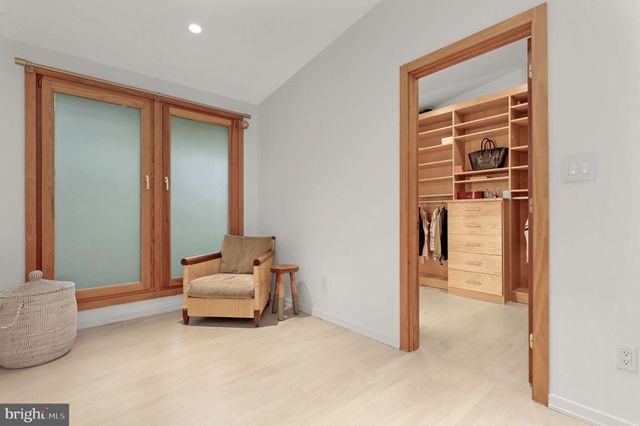 a living room with a bed furniture and a large window