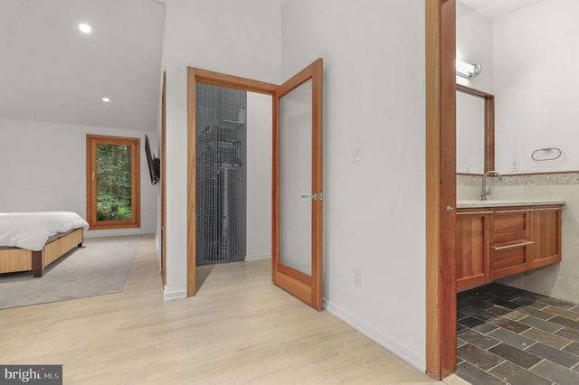 a bathroom with a toilet sink a shower and a mirror