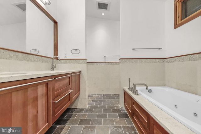 a hallway with a large window and chandelier