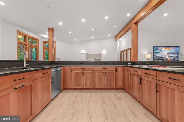 a kitchen with granite countertop a refrigerator and a stove