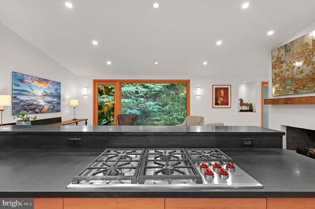 a kitchen with stainless steel appliances granite countertop a stove a sink dishwasher and a refrigerator