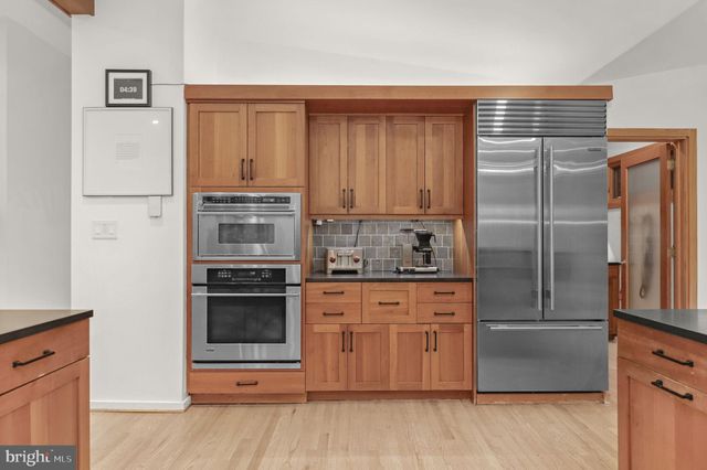 a kitchen with stainless steel appliances granite countertop a sink and a stove