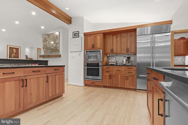 a living room with fireplace furniture and a wooden floor