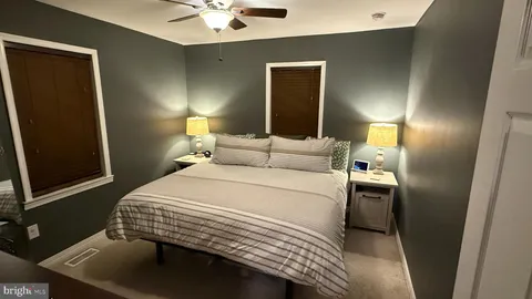 a bedroom with a bed and a lamp