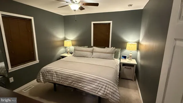 a bedroom with a bed and a lamp