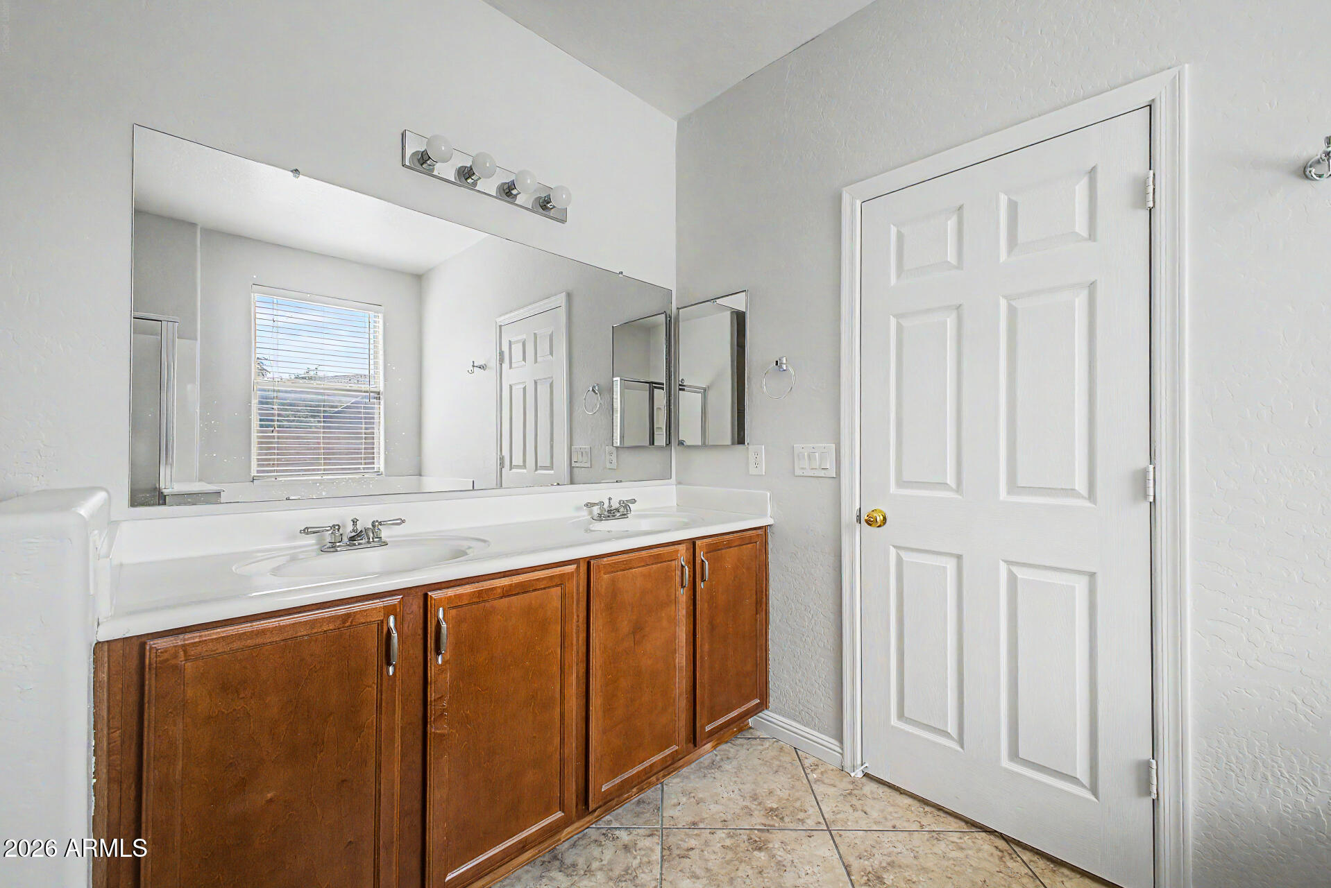 45449 West Tucker Road Maricopa, AZ 85139 - Photo 15 of 46 a bathroom with a double vanity sink and a mirror