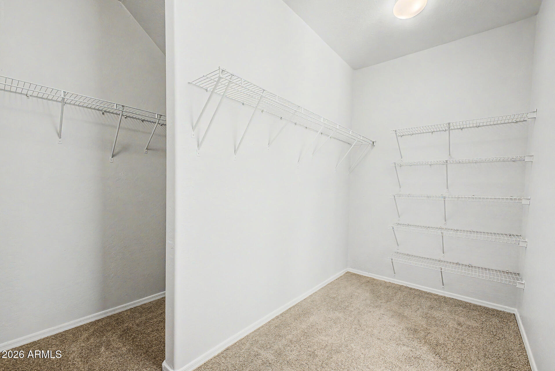 45449 West Tucker Road Maricopa, AZ 85139 - Photo 17 of 46 a view of walk in closet with empty racks