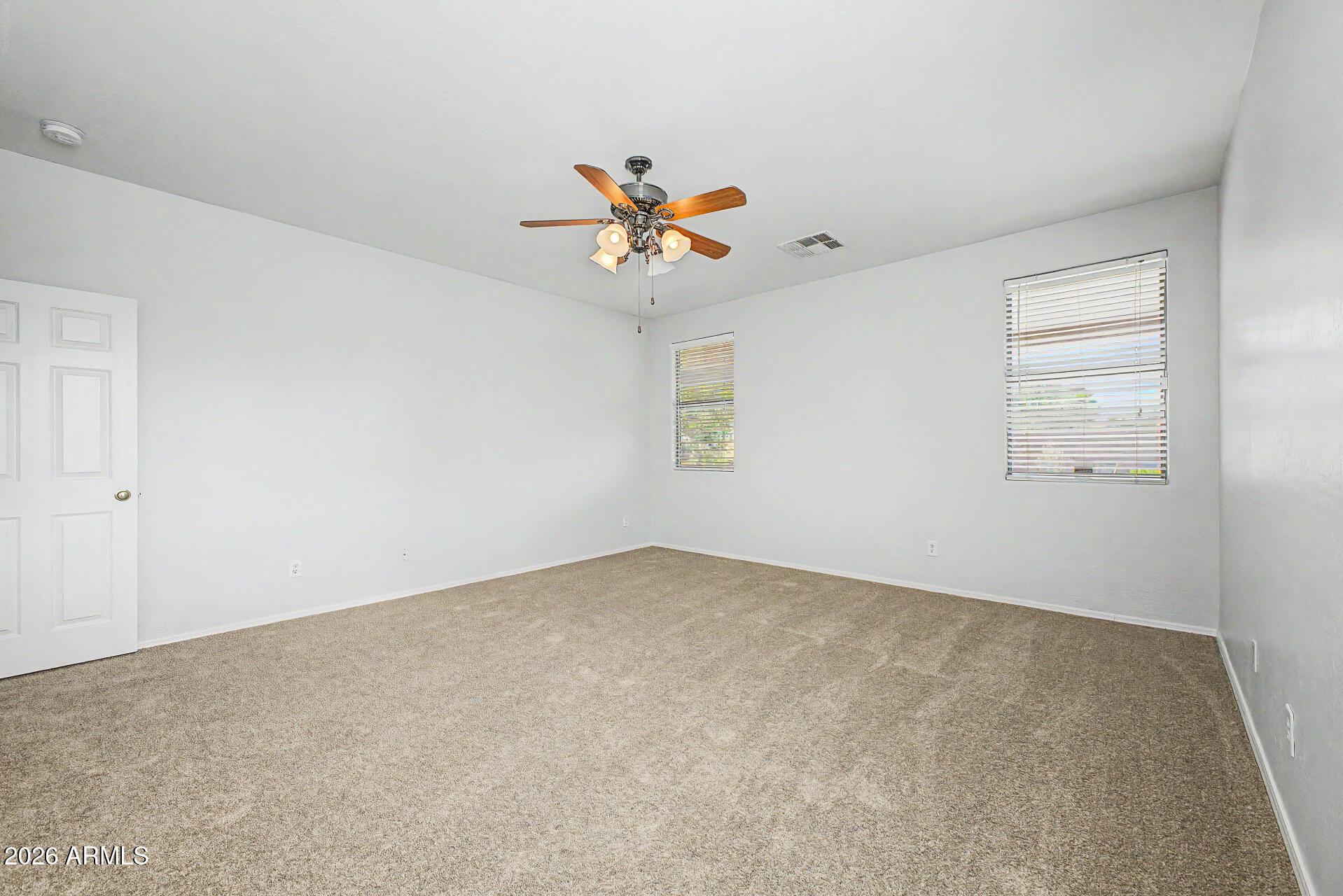45449 West Tucker Road Maricopa, AZ 85139 - Photo 23 of 46 an empty room with windows and fan
