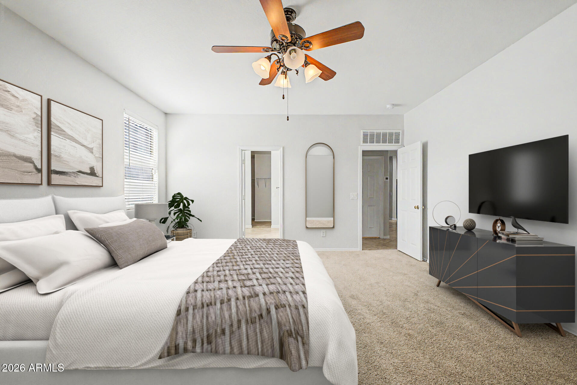 45449 West Tucker Road Maricopa, AZ 85139 - Photo 24 of 46 a bedroom with a bed and a flat screen tv