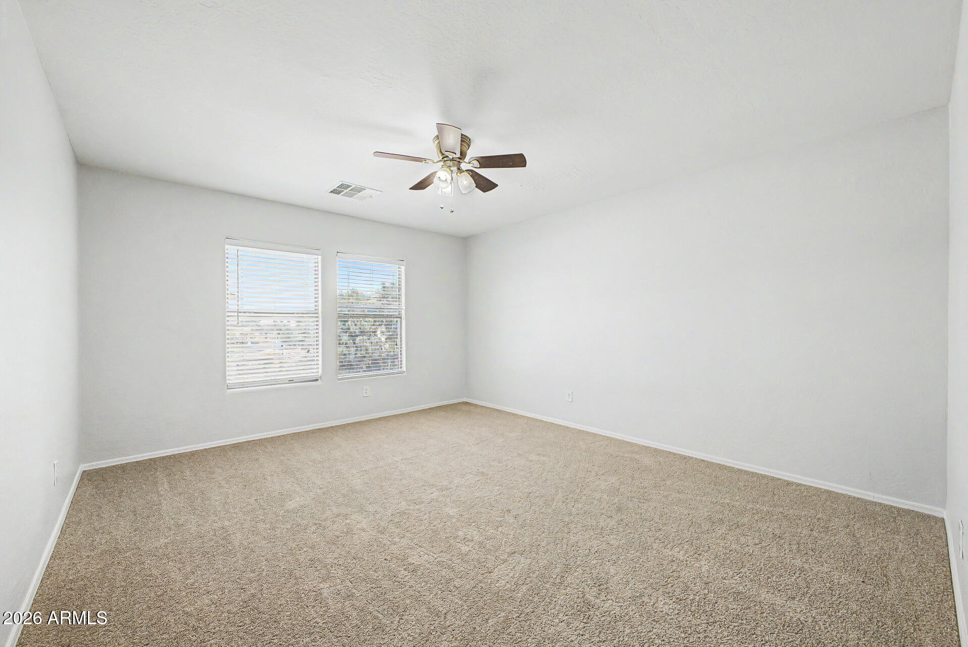 45449 West Tucker Road Maricopa, AZ 85139 - Photo 26 of 46 an empty room with a window and a ceiling fan