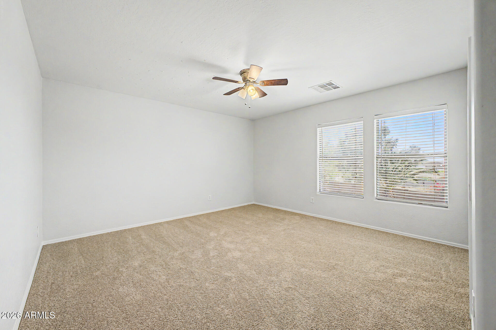 45449 West Tucker Road Maricopa, AZ 85139 - Photo 29 of 46 an empty room with windows and fan