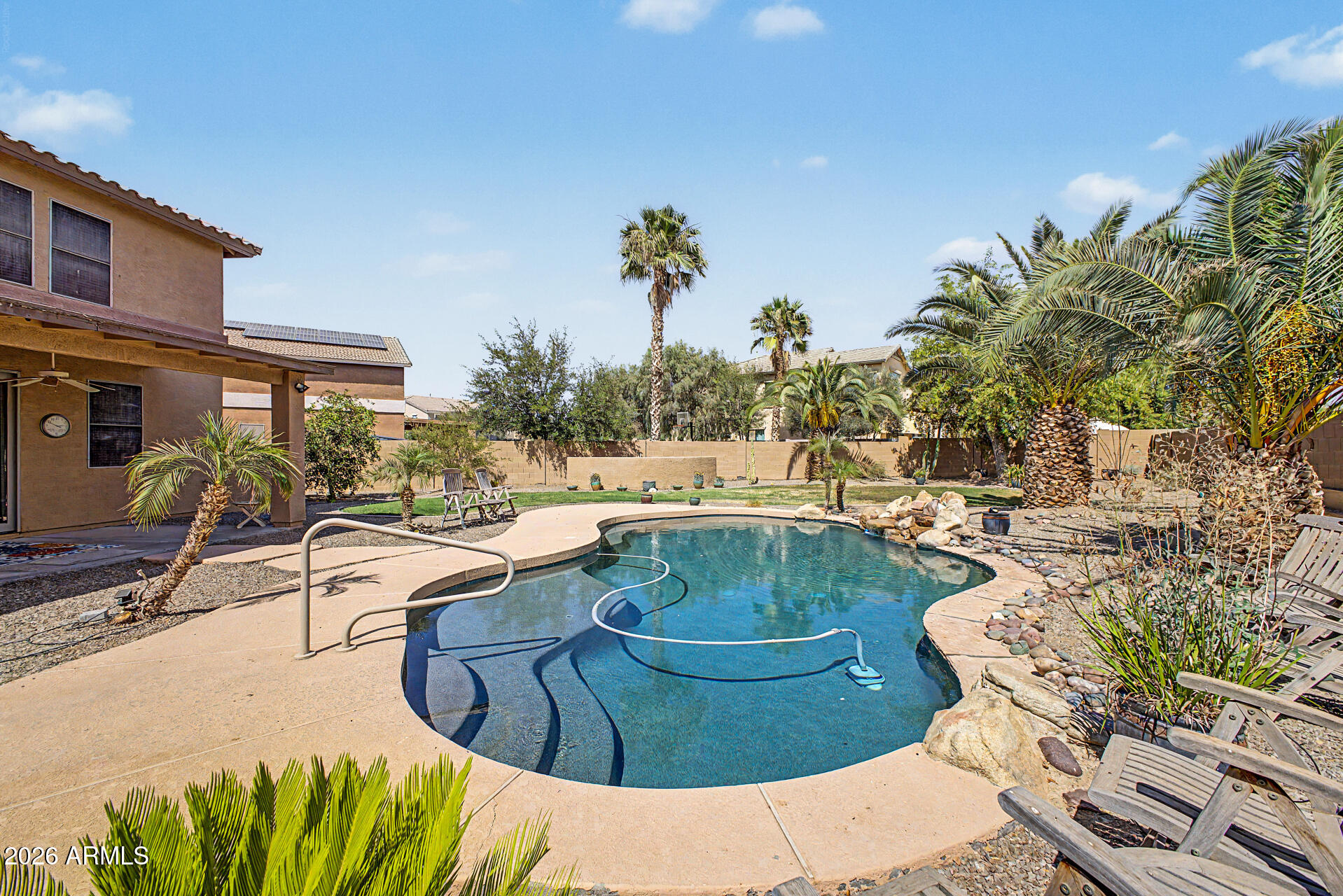 45449 West Tucker Road Maricopa, AZ 85139 - Photo 35 of 46 a view of a swimming pool with a patio and plants