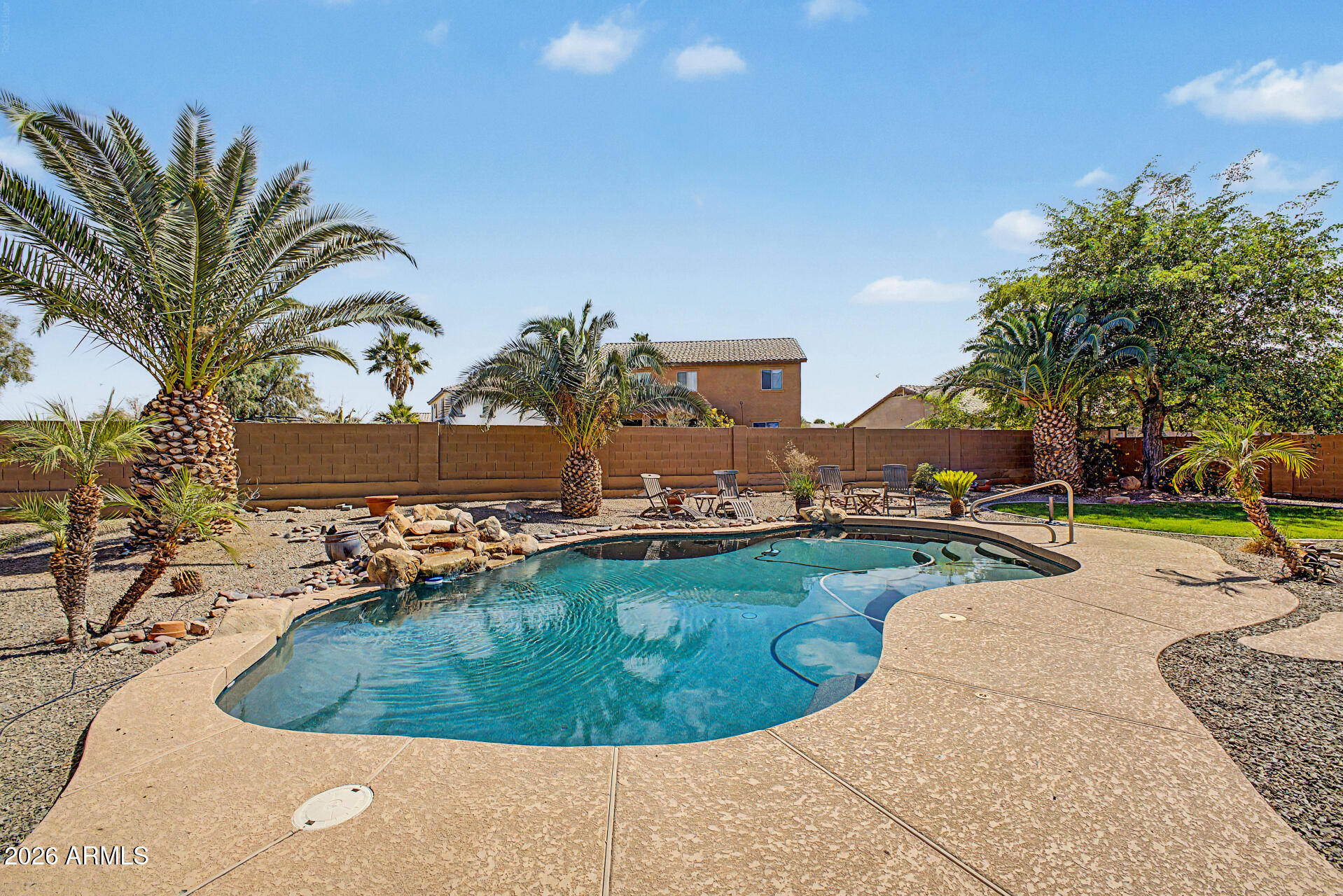 45449 West Tucker Road Maricopa, AZ 85139 - Photo 36 of 46 a view of a swimming pool with a yard and sitting area