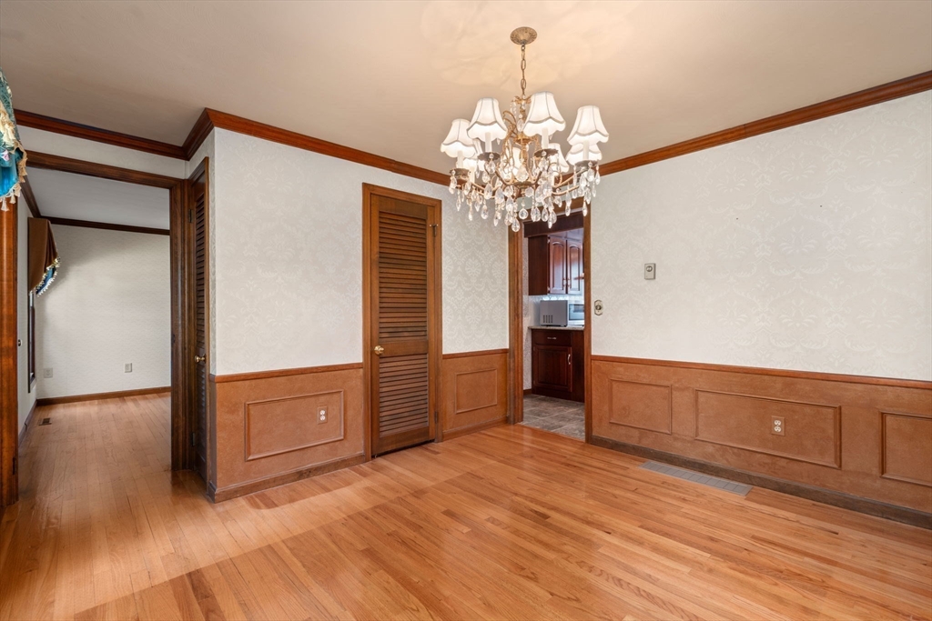 2035 Parker Street Springfield, MA 01128 - Photo 18 of 42 a view of a livingroom with wooden floor and chandelier