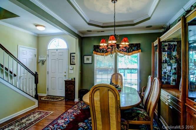 207 Snead Road, Unit 207 Fort Mill, SC 29715 - Photo 2 of 19 a dining room with furniture a chandelier and window