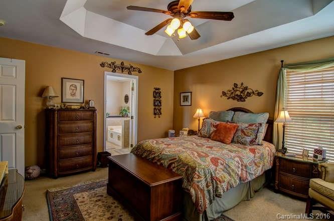 207 Snead Road, Unit 207 Fort Mill, SC 29715 - Photo 14 of 19 a bedroom with a bed and a chandelier