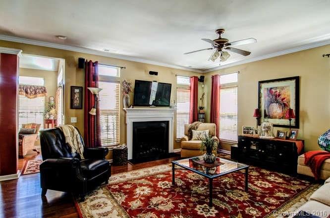207 Snead Road, Unit 207 Fort Mill, SC 29715 - Photo 7 of 19 a living room with furniture a fireplace and a flat screen tv