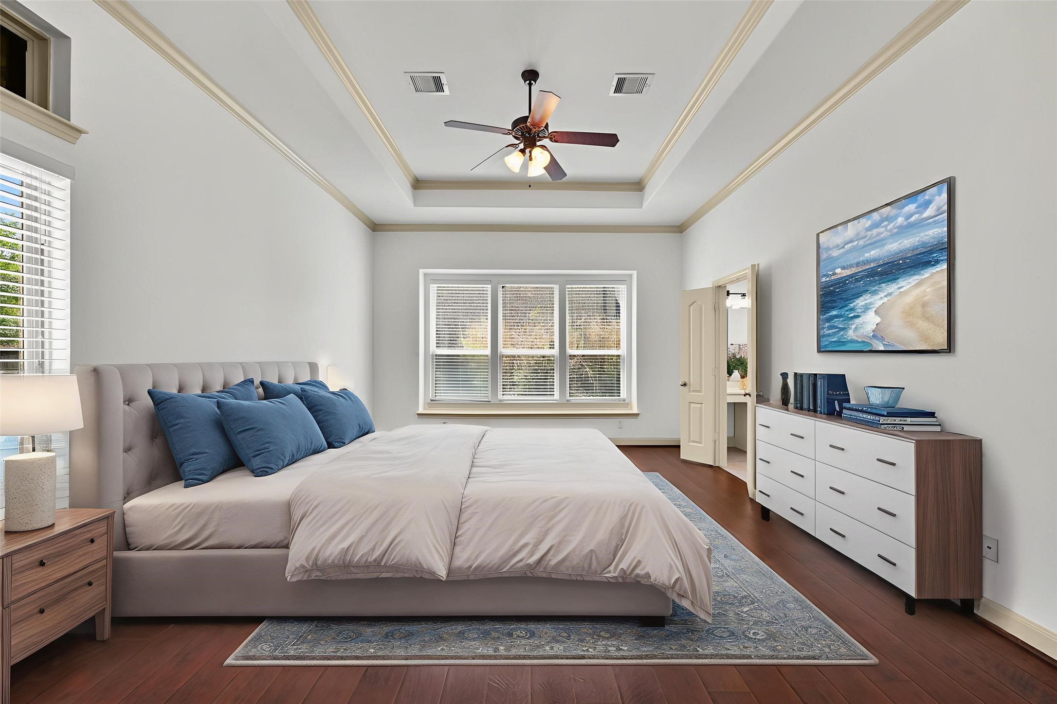 4603 Red Hawk Court Sugar Land, TX 77479 - Photo 20 of 50 a bedroom with a large bed and a chandelier