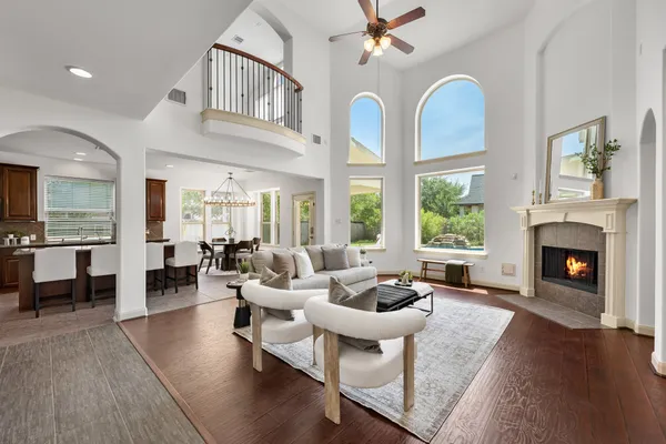 a living room with furniture fireplace and a large window