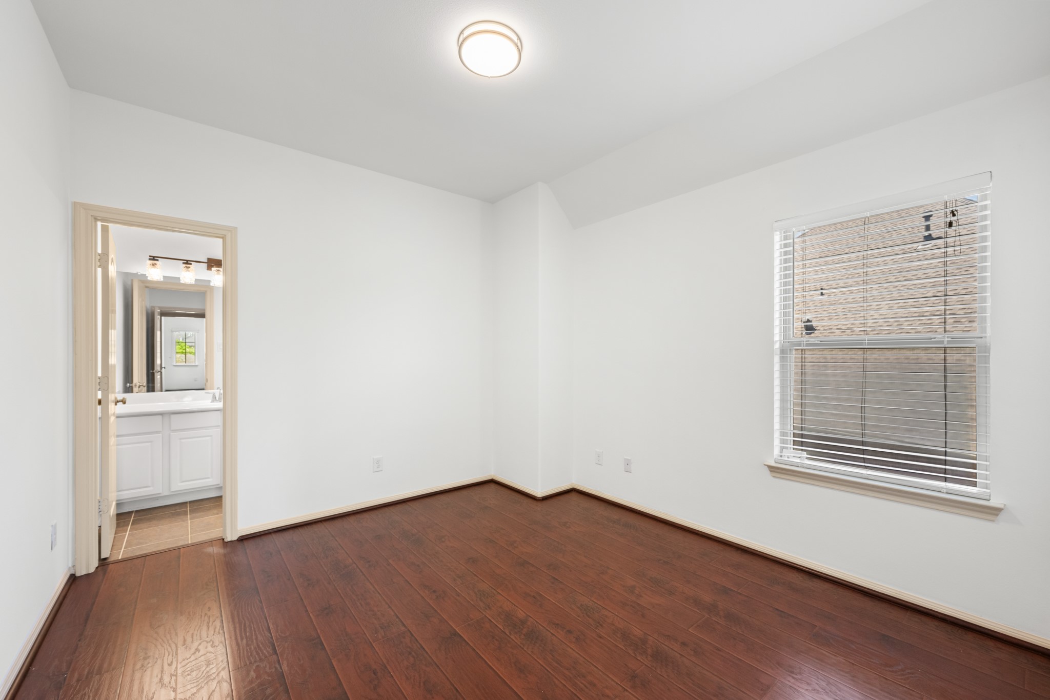 4603 Red Hawk Court Sugar Land, TX 77479 - Photo 34 of 50 an empty room with wooden floor and windows