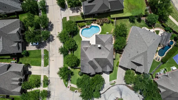 an aerial view of a house with outdoor space and a garden