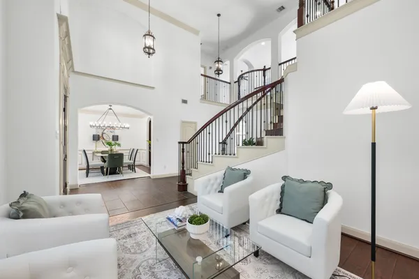 a living room with furniture and a chandelier