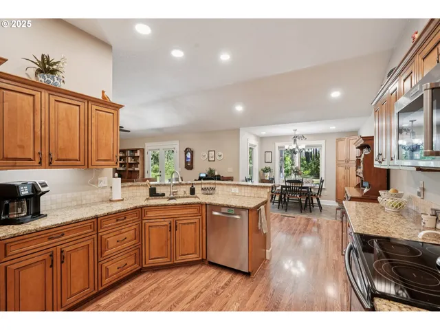 a kitchen with stainless steel appliances granite countertop a sink counter space and cabinets