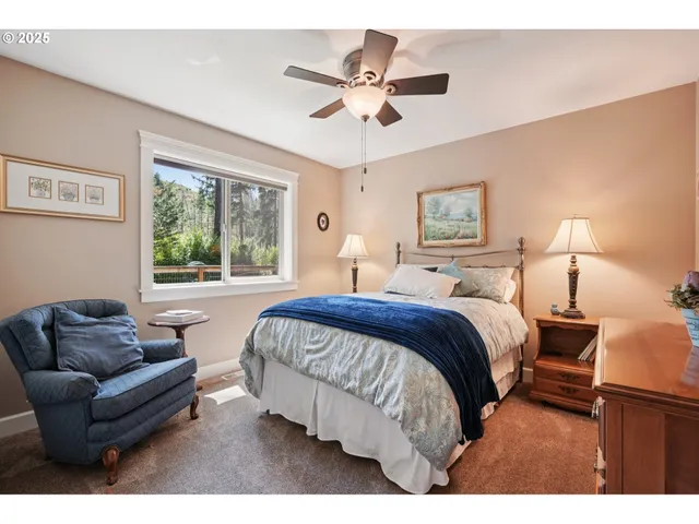 a spacious bedroom with a bed couch and window