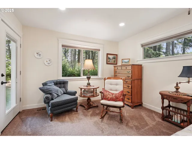 a living room with furniture a rug and a window