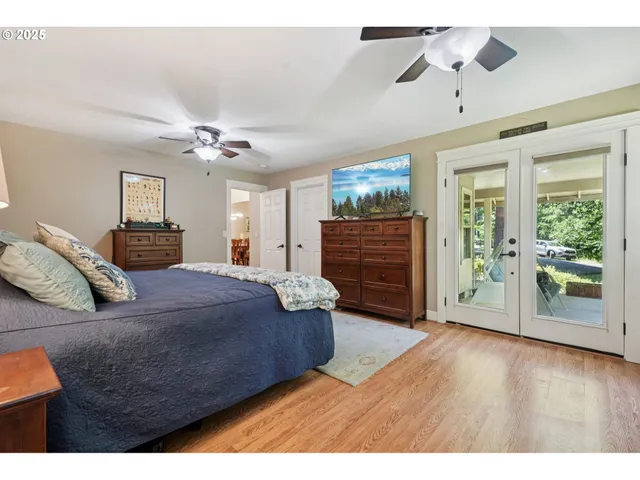 a bedroom with a large bed and a chandelier