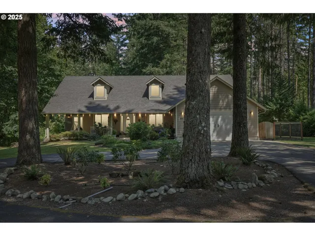 a view of a house with a yard and tree s