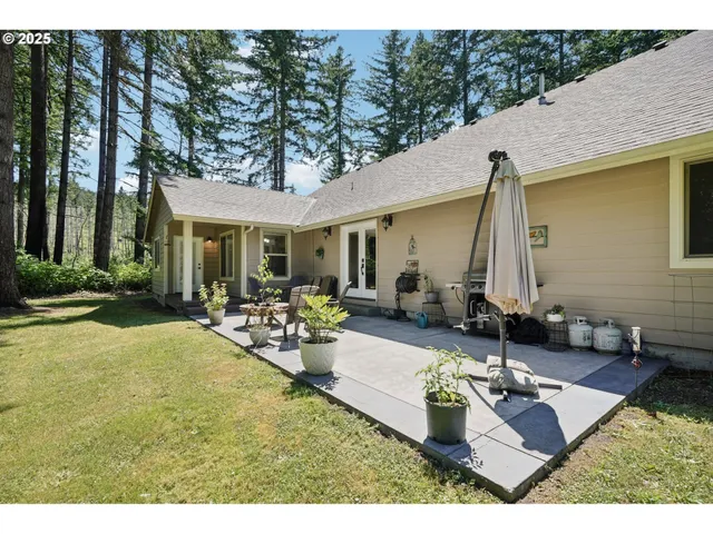 a view of house and yard with patio
