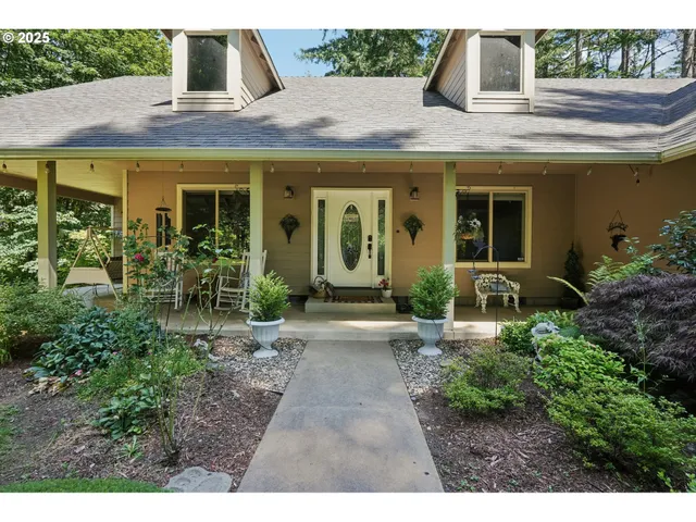 a view of a house with potted plants and a table