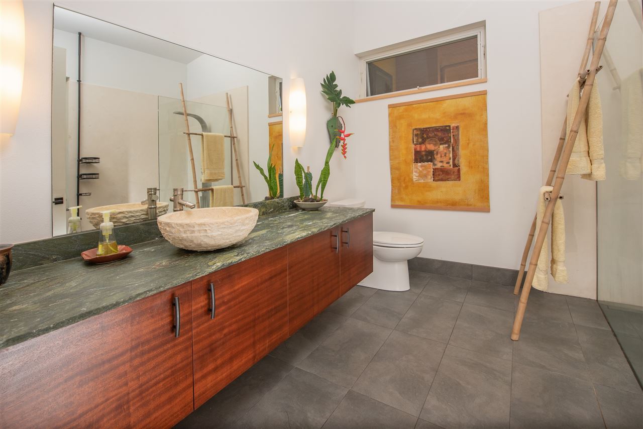 525 North Honokala Road Haiku, HI 96708 - Photo 16 of 30 a bathroom with a granite countertop sink and a mirror