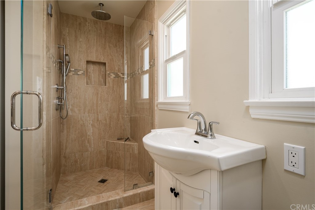 12430 Beverly Drive Whittier, CA 90601 - Photo 11 of 31 a bathroom with a sink a mirror and shower