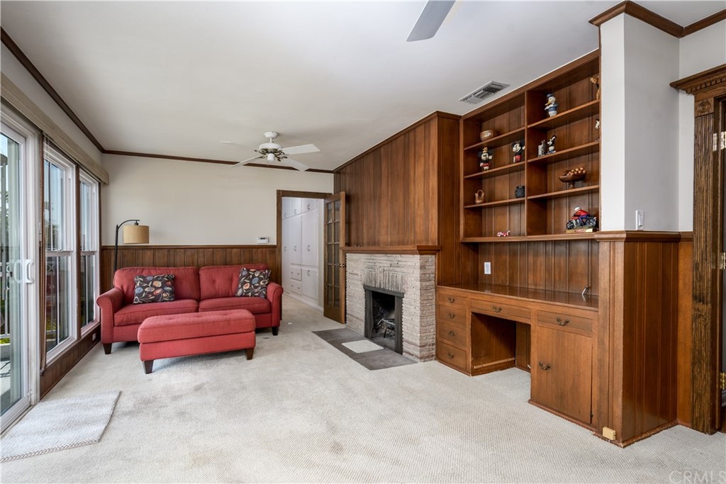 12430 Beverly Drive Whittier, CA 90601 - Photo 13 of 31 a living room with furniture a fireplace and a book shelf