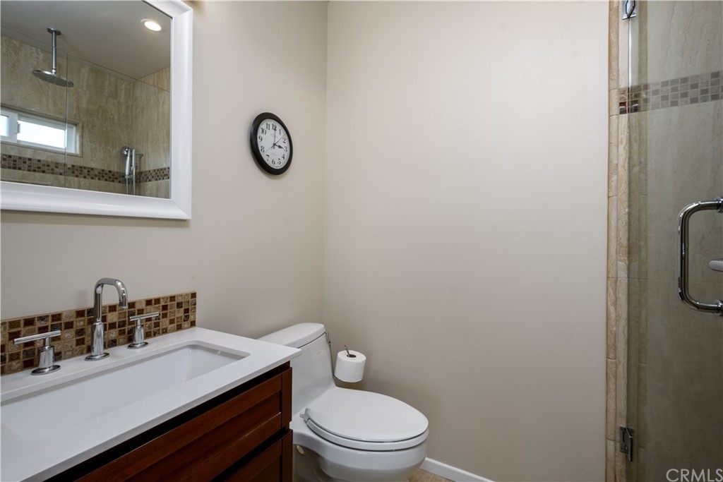 12430 Beverly Drive Whittier, CA 90601 - Photo 17 of 31 a bathroom with a granite countertop toilet sink and mirror
