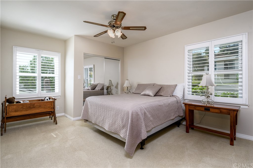 12430 Beverly Drive Whittier, CA 90601 - Photo 18 of 31 a spacious bedroom with a bed and a chandelier